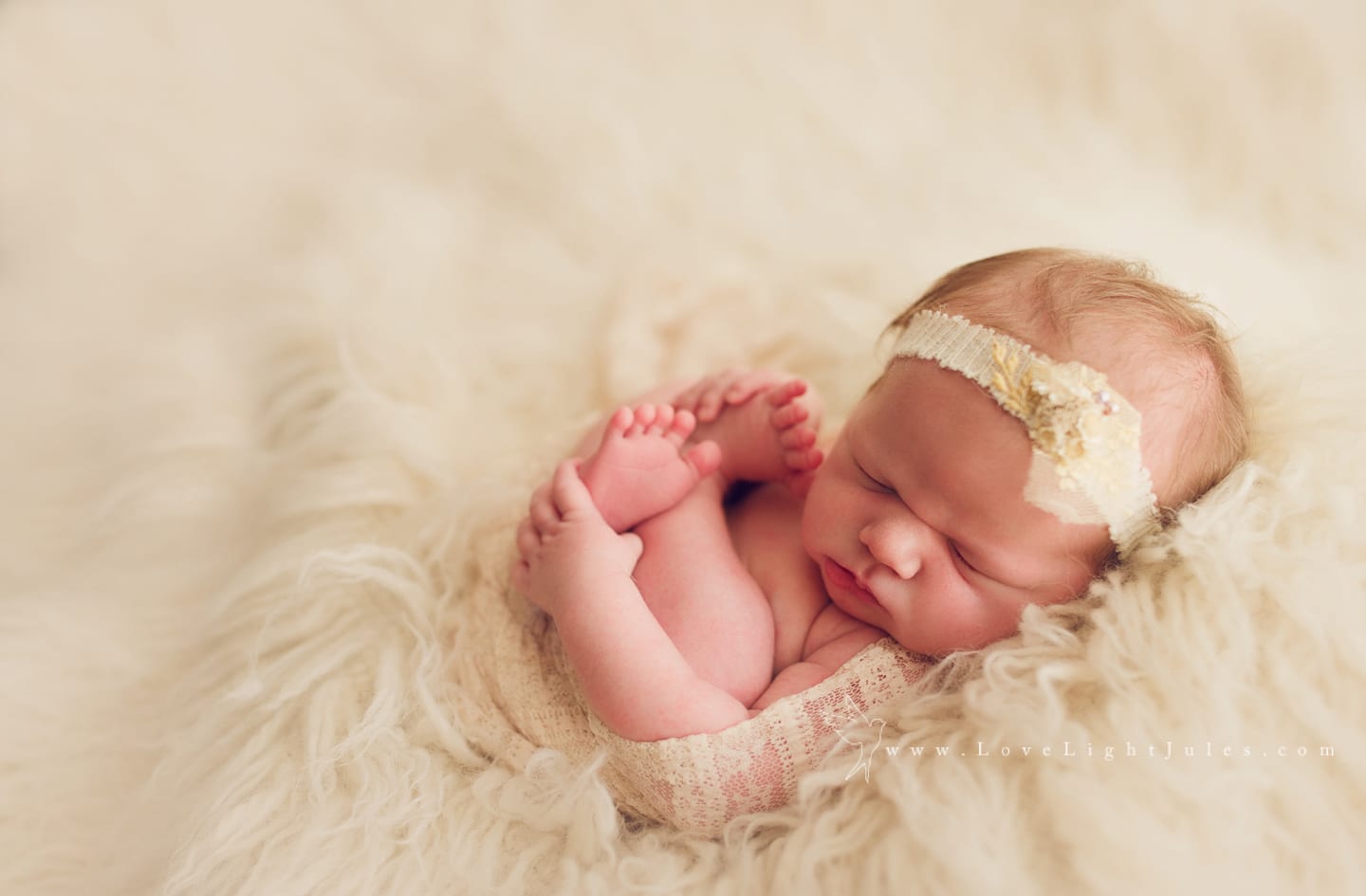 image-of-newborn-baby-against-white-flokati-and-white-headband