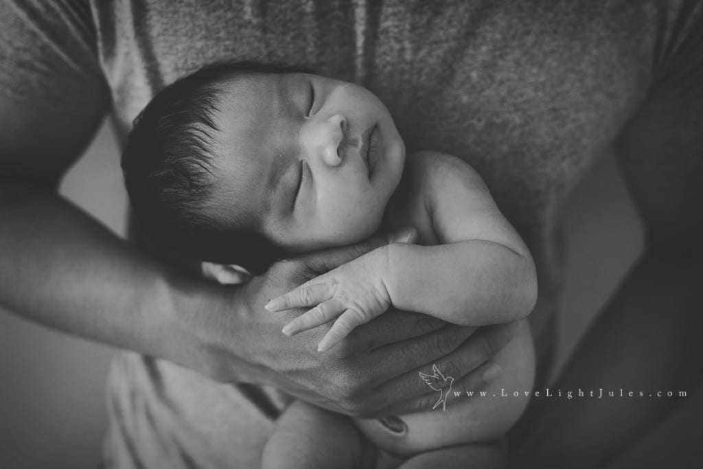 in-daddys-hands-newborn-pose-by-sacramento-photographer