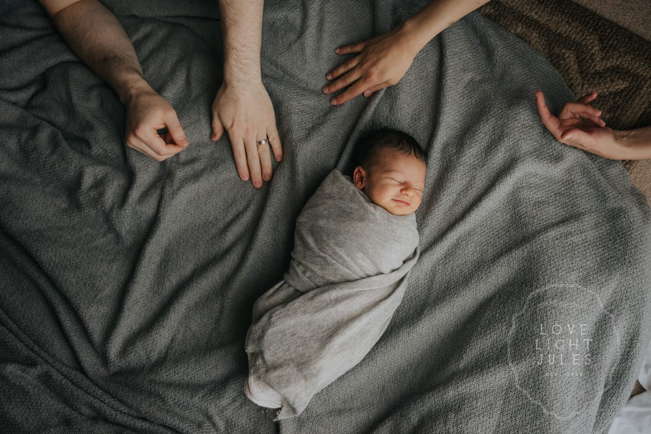 baby-on-blanket-during-lifestyle-newborn-shoot