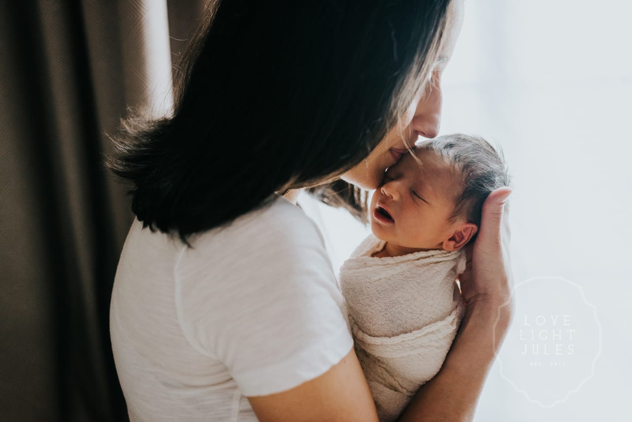 backlit-photograph-of-mother-and-newborn-baby-in-sacramento-home