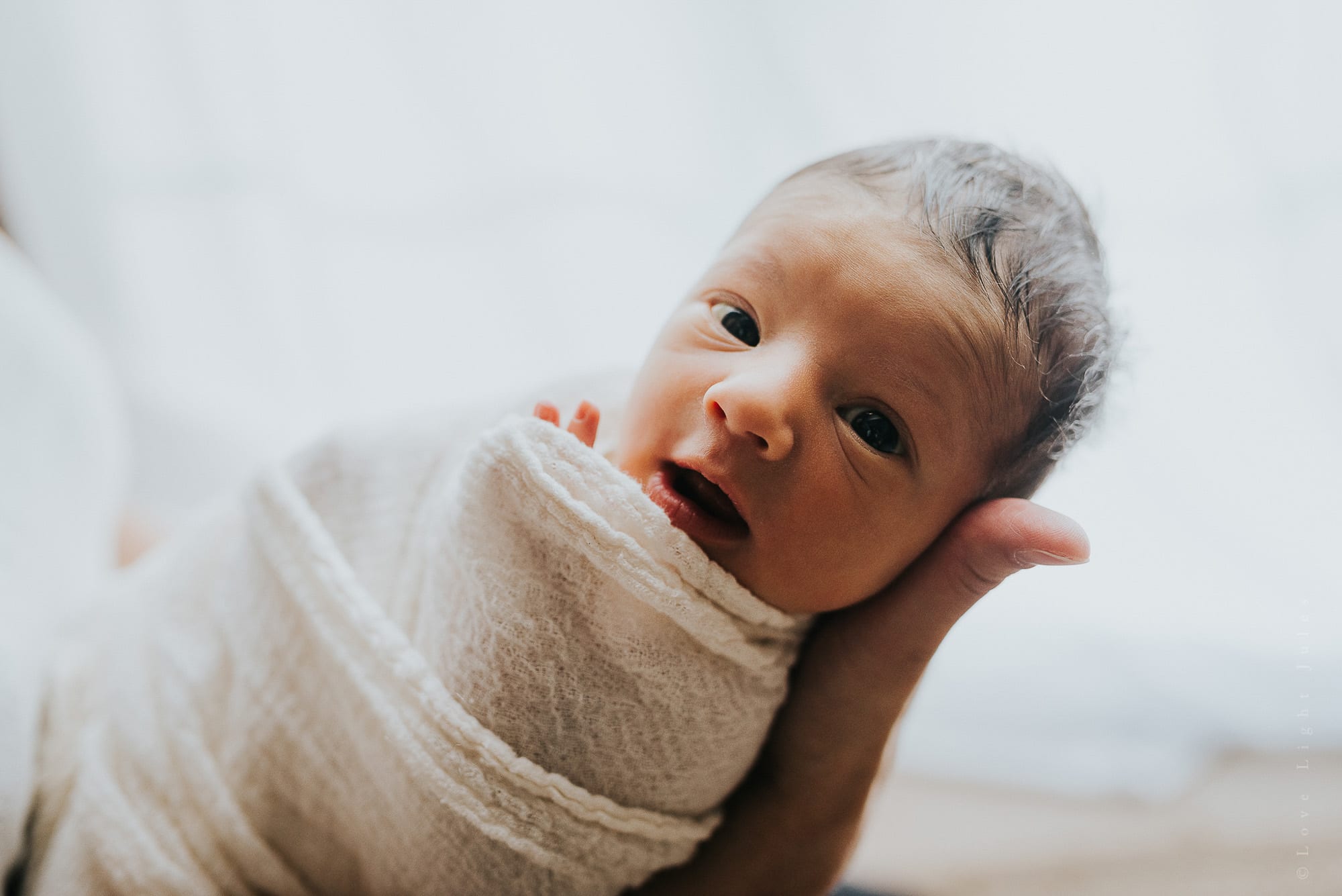 newborn-baby-smiling-at-camera-at-sacramento-home-newborn-session