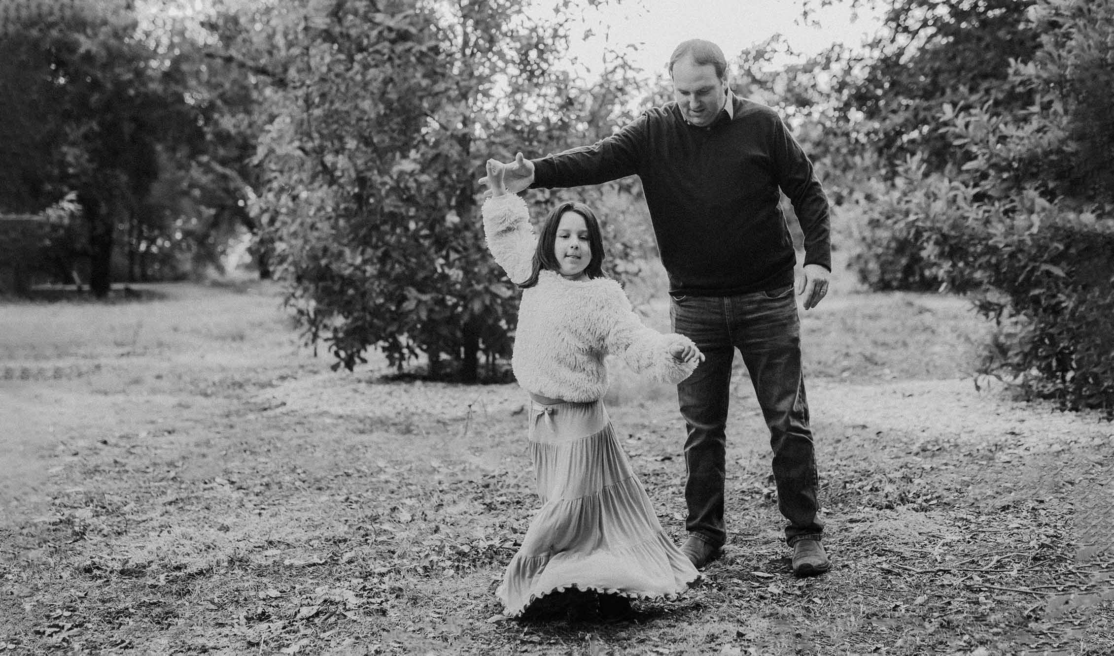 father-twirling-daughter-during-photo-shoot-at-ruth-risdon-garden