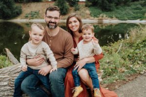 Portrait of family sitting by Arboretum in Davis, CA